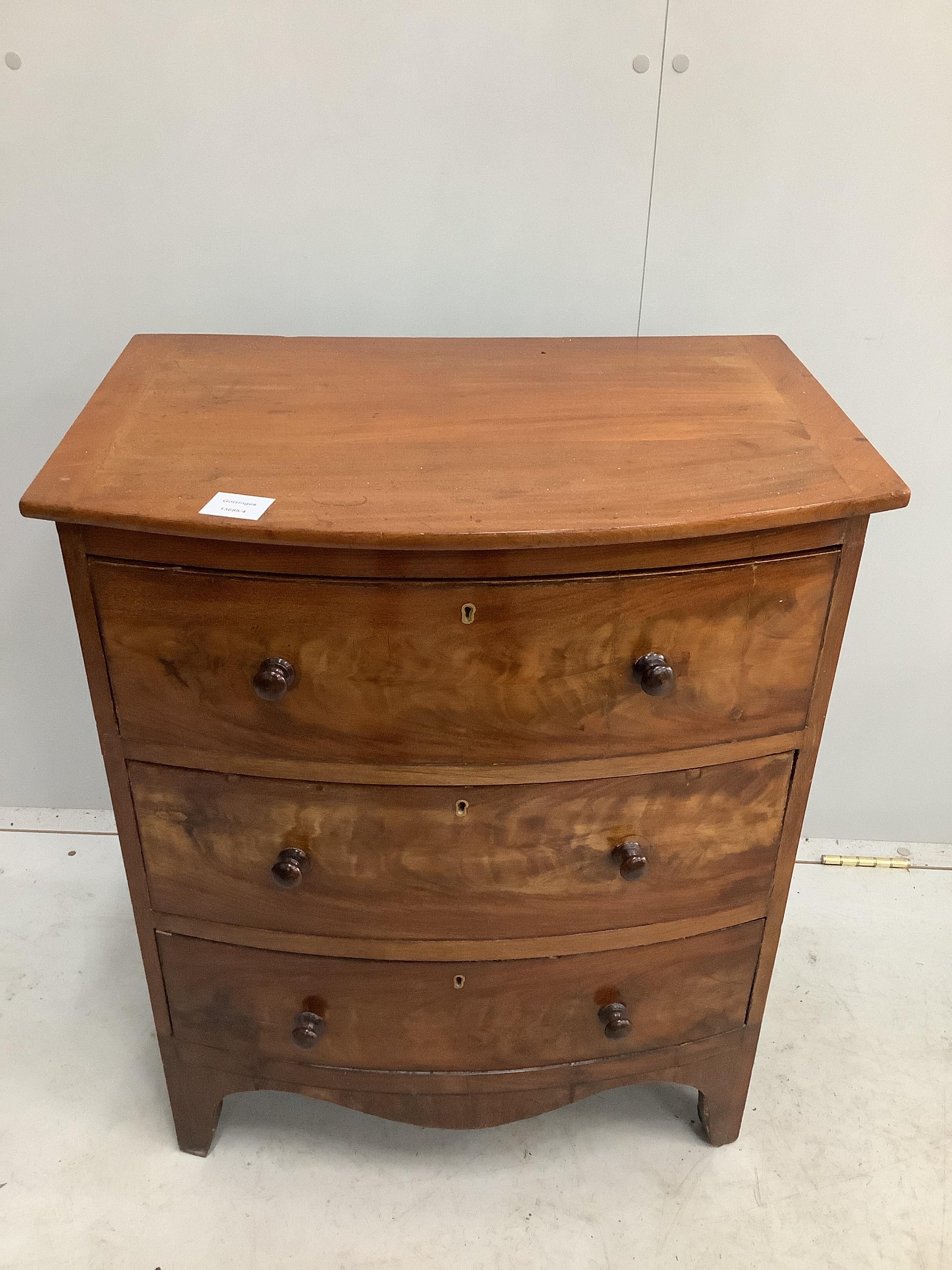 A small Regency mahogany bowfront chest of three drawers, converted from a commode, width 58cm, depth 39cm, height 69cm